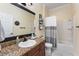 Bathroom featuring a granite vanity, white sink, toilet, and a shower-tub combo at 4955 Ne 124Th Rd, Oxford, FL 34484