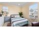 Bright bedroom with tiled floors featuring a queen bed, window air conditioner, and neutral tones at 4955 Ne 124Th Rd, Oxford, FL 34484