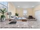 Bedroom featuring a kitchenette area, queen bed, and decor with neutral color tones at 4955 Ne 124Th Rd, Oxford, FL 34484