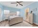 Bedroom with a ceiling fan, wood floors, a chest, and an ensuite bathroom at 4955 Ne 124Th Rd, Oxford, FL 34484