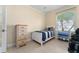 Cozy bedroom showcasing tile floors, a large window, and a twin bed at 4955 Ne 124Th Rd, Oxford, FL 34484