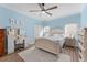 Light and airy bedroom featuring a ceiling fan, light blue walls, and a large bed at 4955 Ne 124Th Rd, Oxford, FL 34484