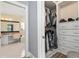 Walk-in closet leads to a view of a full bathroom, with a vanity and shower at 4955 Ne 124Th Rd, Oxford, FL 34484