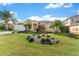 Beautifully landscaped front yard with a charming single-story home and a well-manicured lawn at 4955 Ne 124Th Rd, Oxford, FL 34484