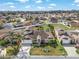 A well-maintained home featuring a two-car garage, lovely landscaping, and a circular flower bed in the front yard at 4955 Ne 124Th Rd, Oxford, FL 34484