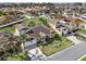 Aerial view of a well-manicured lawn and landscaping surrounding the home, complemented by a screened-in patio at 4955 Ne 124Th Rd, Oxford, FL 34484