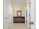 Hallway with a wood cabinet and access to other areas of the home at 4955 Ne 124Th Rd, Oxford, FL 34484