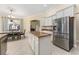 Open-concept kitchen boasts stainless steel appliances, central island and attached dining area at 4955 Ne 124Th Rd, Oxford, FL 34484