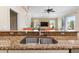 Kitchen sink with granite countertops overlooking the living room area at 4955 Ne 124Th Rd, Oxford, FL 34484