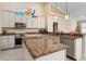 Stylish kitchen featuring granite countertops, a central island, and stainless steel appliances at 4955 Ne 124Th Rd, Oxford, FL 34484