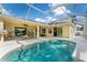 Beautiful screened-in pool area featuring a pool with a waterfall and outdoor seating, perfect for relaxing and entertaining at 4955 Ne 124Th Rd, Oxford, FL 34484