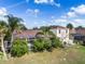 An aerial view of the rear of a house with a screened-in pool area and tropical landscaping at 4955 Ne 124Th Rd, Oxford, FL 34484