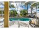 Beautiful screened-in pool with a small waterfall feature and patio furniture, perfect for relaxation and entertaining at 4955 Ne 124Th Rd, Oxford, FL 34484