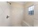 Tiled shower with bench seat and window providing natural light at 4955 Ne 124Th Rd, Oxford, FL 34484