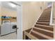 View of the staircase and laundry room featuring a washer and dryer with shelving at 4955 Ne 124Th Rd, Oxford, FL 34484