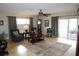 Cozy living room boasts hardwood floors, neutral walls, and ample natural light from sliding glass doors at 519 Balsawood Ct, Altamonte Springs, FL 32714