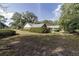 A lush green backyard with mature trees surrounds this home at 5200 Ne 20 St, Ocala, FL 34470