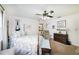 This bedroom features a four-poster bed and vintage decor with a ceiling fan to keep it cool at 5200 Ne 20 St, Ocala, FL 34470