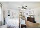 Cozy bedroom featuring a four-poster bed, ceiling fan, and coastal decor at 5200 Ne 20 St, Ocala, FL 34470