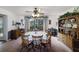 Inviting dining room with classic wood furniture, ceiling fan and a garden view window at 5200 Ne 20 St, Ocala, FL 34470