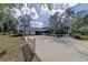 Wide driveway leading to a two-car garage in a brick home with manicured landscaping at 5200 Ne 20 St, Ocala, FL 34470