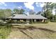 Charming brick home with a manicured lawn and traditional architectural details at 5200 Ne 20 St, Ocala, FL 34470