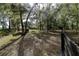 Beautiful wooded land with a tall fence, and a small structure at 5200 Ne 20 St, Ocala, FL 34470