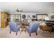 Cozy living room features neutral color palette with sitting area and traditional furnishings with lots of windows at 5200 Ne 20 St, Ocala, FL 34470