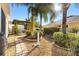 Landscaped backyard featuring a stone walkway and various plants, complemented by a pergola-covered seating area at 544 Audrey Ln, The Villages, FL 32162