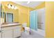 Bright bathroom features a single sink vanity, and shower and tub combo at 544 Audrey Ln, The Villages, FL 32162