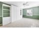 Bedroom with carpet, built-in shelves, storage and closet space, and good light from the window at 544 Audrey Ln, The Villages, FL 32162