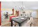 Open dining room with modern table and chairs next to the updated kitchen at 544 Audrey Ln, The Villages, FL 32162