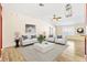 Elegant living room featuring stylish decor, wood-look floors, and an abundance of natural light at 544 Audrey Ln, The Villages, FL 32162