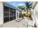 Cozy patio with blue striped awning providing an outdoor space to relax surrounded by plants and trees at 544 Audrey Ln, The Villages, FL 32162