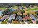 Aerial view of the houses, the community pond, golf course and parking lot at 544 Grand Vista Trl, Leesburg, FL 34748