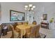 Cozy dining room with charming chandelier, decorative mirror, and seating for six around a table with yellow tablecloth at 544 Grand Vista Trl, Leesburg, FL 34748