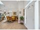 Bright foyer featuring tile flooring with decorative border, front door with sidelight, and an open view to the dining area at 544 Grand Vista Trl, Leesburg, FL 34748