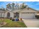 Charming home featuring a well-maintained lawn and an attached two-car garage at 544 Grand Vista Trl, Leesburg, FL 34748