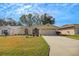 Charming single-story home with well-maintained lawn and landscaping, featuring a two-car garage and inviting entryway at 544 Grand Vista Trl, Leesburg, FL 34748