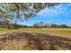 Golf course with a clear sky and golf carts on the background at 544 Grand Vista Trl, Leesburg, FL 34748