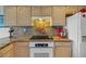 This kitchen features granite countertops, light wood cabinets and recessed lighting at 544 Grand Vista Trl, Leesburg, FL 34748