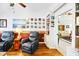 Well-decorated living room featuring leather recliners, built-in shelves, and easy access to adjacent rooms at 544 Grand Vista Trl, Leesburg, FL 34748