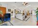 Open-concept living room with tile flooring, skylight, and neutral color palette at 544 Grand Vista Trl, Leesburg, FL 34748