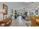 Bright living room with an open floor plan featuring tile floors and a ceiling fan at 544 Grand Vista Trl, Leesburg, FL 34748