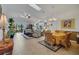 Bright living room with an open floor plan featuring large windows and a ceiling fan at 544 Grand Vista Trl, Leesburg, FL 34748