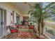 Bright sunroom with golf course view, ceiling fan, and comfortable seating on an eye-catching rug at 544 Grand Vista Trl, Leesburg, FL 34748