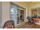 Bright sunroom with sliding door into bedroom, ceiling fan, and comfortable seating on an eye-catching rug at 544 Grand Vista Trl, Leesburg, FL 34748