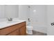 Bright bathroom featuring a modern vanity with light countertops and tiled shower over tub at 559 Juniper Springs Dr, Groveland, FL 34736