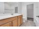 Bright bathroom with tile flooring, wooden cabinets, quartz countertop, and shower-tub combination at 559 Juniper Springs Dr, Groveland, FL 34736