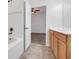 Well-lit bathroom featuring tile floors, a vanity, and a bathtub-shower combo with tiled surround at 559 Juniper Springs Dr, Groveland, FL 34736